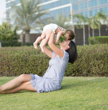 Mother with child in air