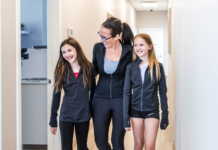 Headaches, Concussions & Back-to-School: What Every Parent Should Know Mom walking with her two daughters through Transcend Headache Clinic after fall sports practice.
