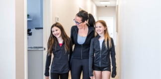 Headaches, Concussions & Back-to-School: What Every Parent Should Know Mom walking with her two daughters through Transcend Headache Clinic after fall sports practice.